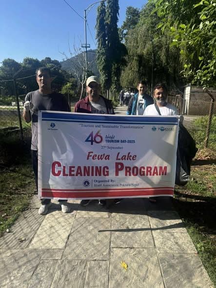 Members with the Fewa Lake Cleaning Program banner